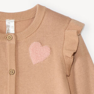 Gebreide stoffen vest voor meisjes met een fantasiepatroon en bouclette-patch. 