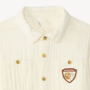 Langarmige babyjongen blouse van dubbele gaze met een fantasiebadge. 