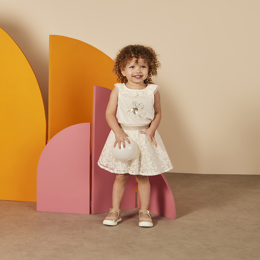 Mouwloos topje met ruchekraag en print in pailletten voor baby meisje 