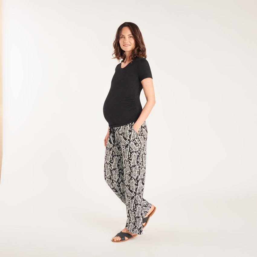 Wide and flowing pants with a high printed waistband for pregnant women. 